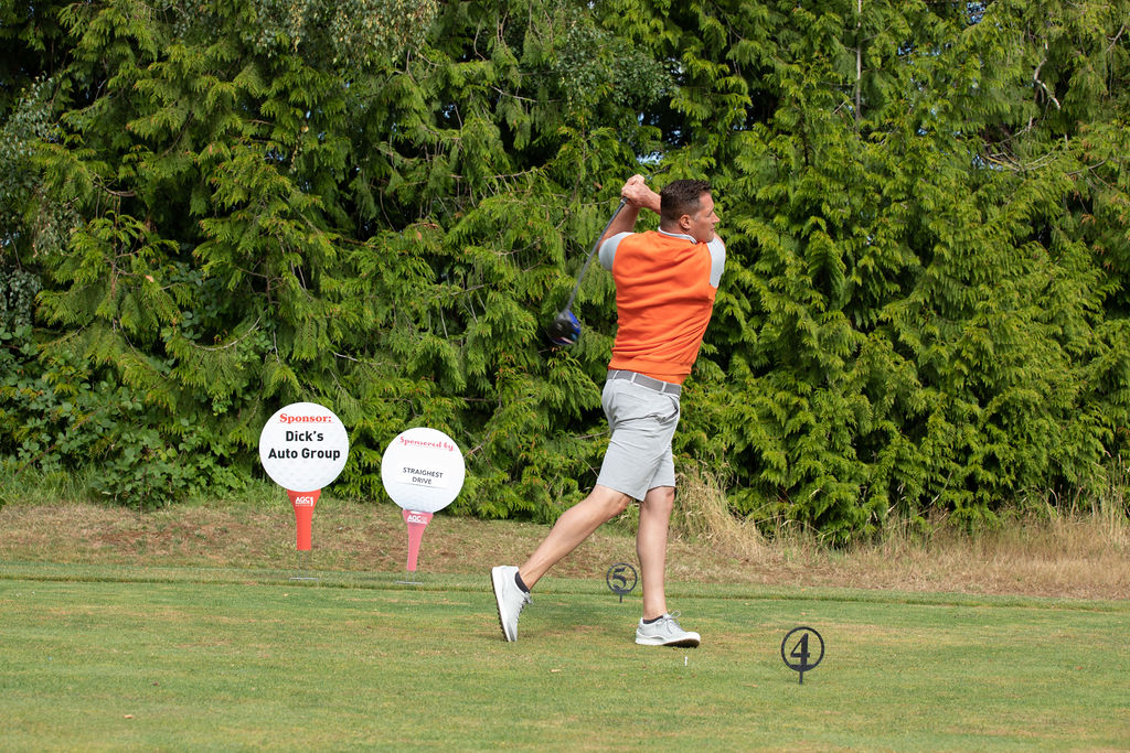 man swinging golf club