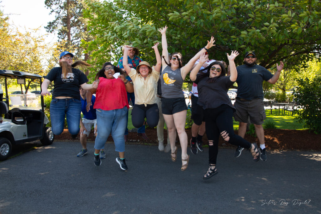 group of people jumping with arms in the air