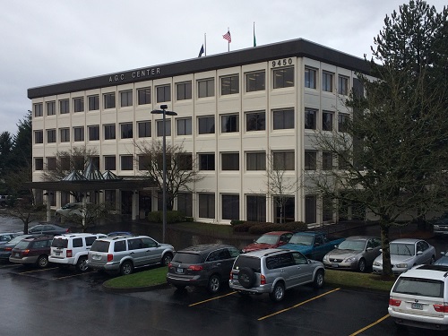 photo of AGC building with cars in parking lot