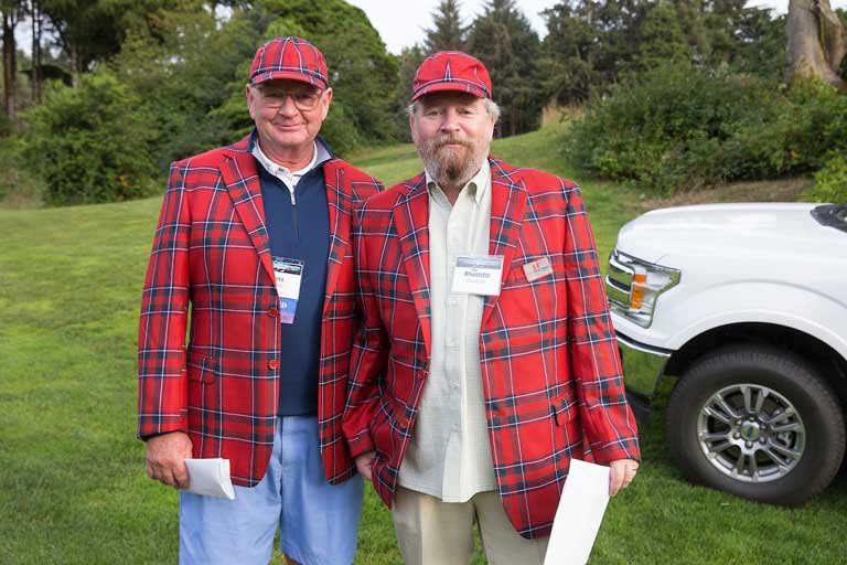 two men wearing plaid jcakets