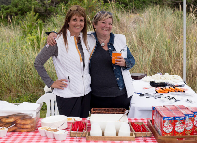 two smiling women with snacks