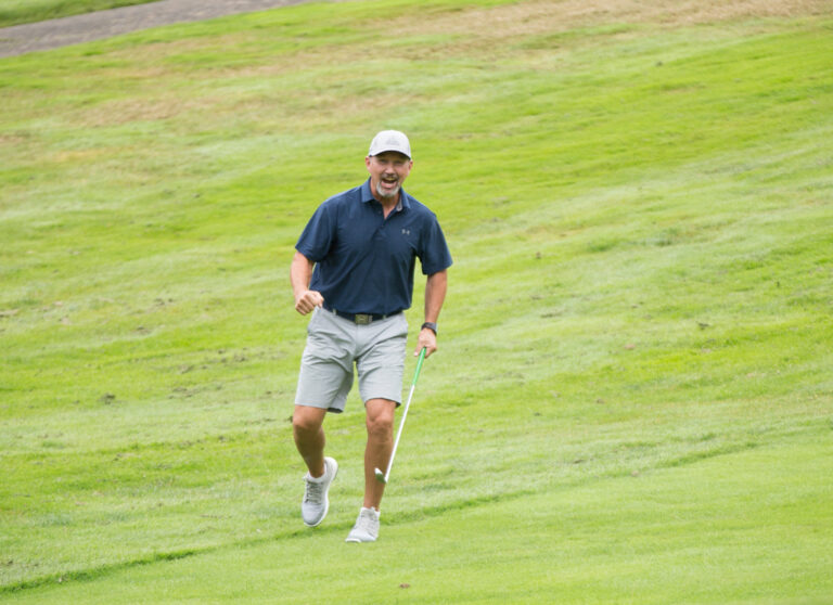 man cheering on golf course