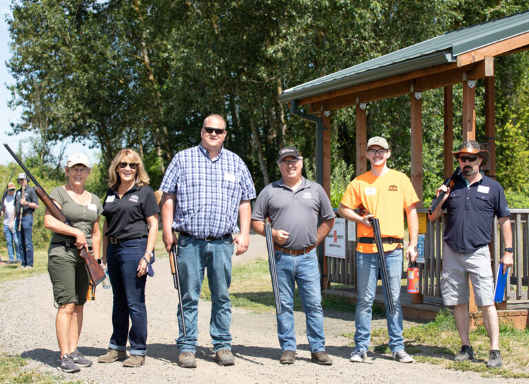 four men and two women at shooting event