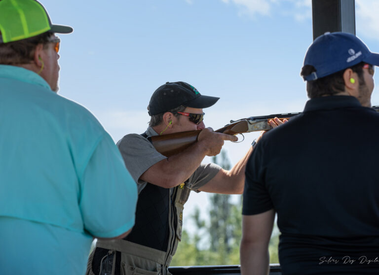 three men at shooting event