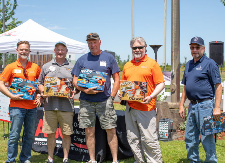 five men holding prizes