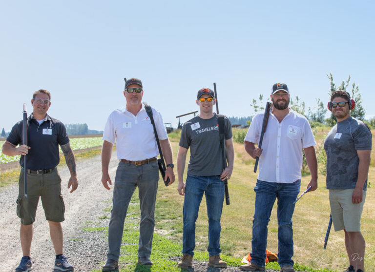 five men posing at shooting event