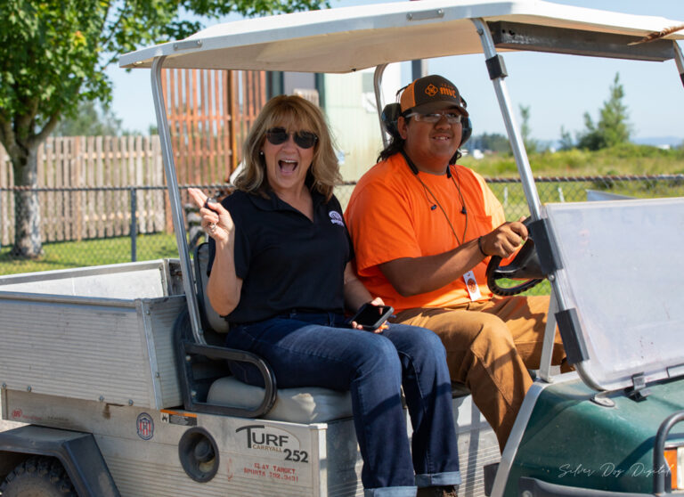 Two people smiling in ATV