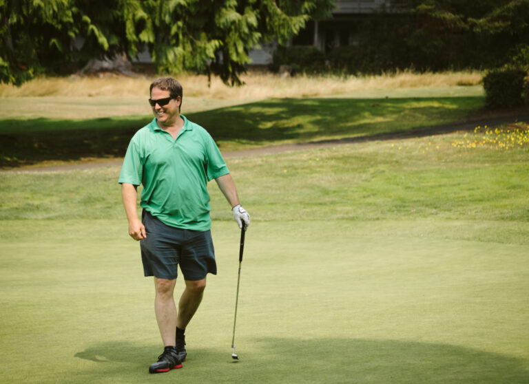 smiling golfer with putter