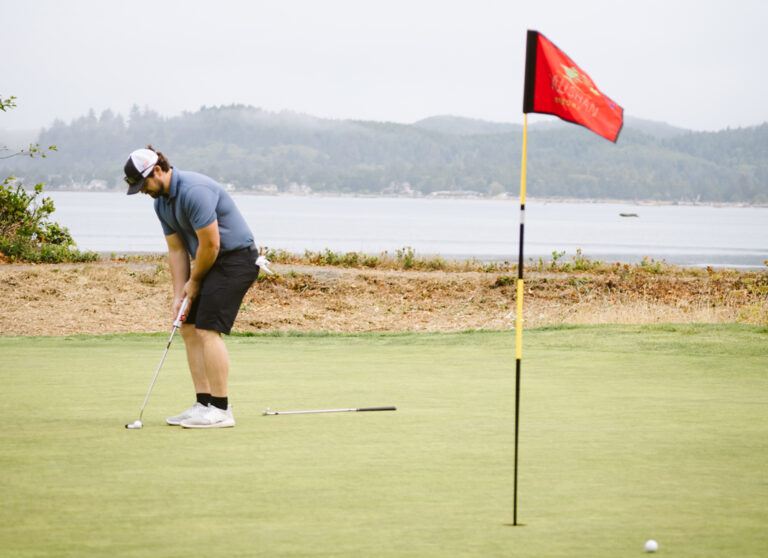 man putting at the beach