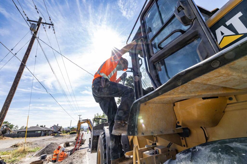 man climbing on construction equipment