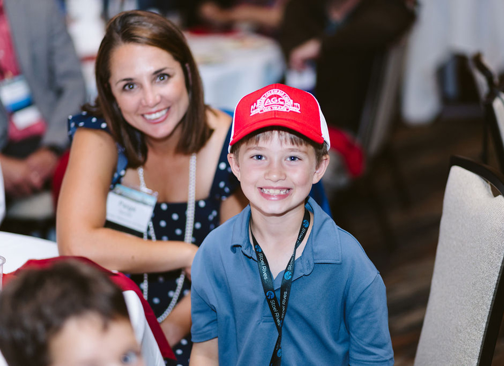 kid smiling with centennial hat