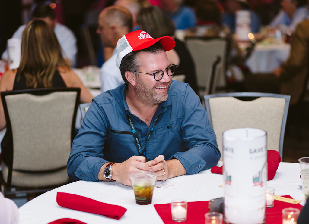 smiling with centennial hat