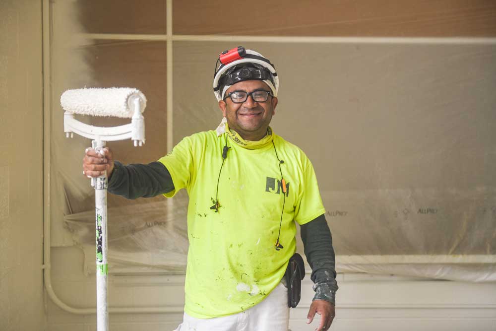 smiling man with paint roller