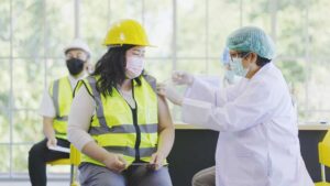 female construction worker getting vaccine