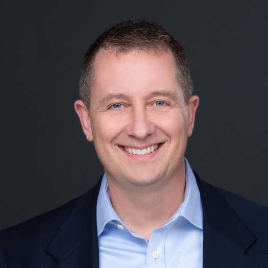 smiling man wearing blue shirt and jacket