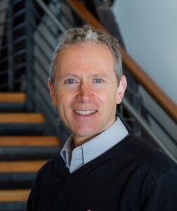 smiling man in collared shirt