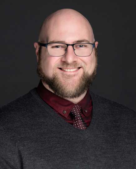 smiling man with a beard and glasses