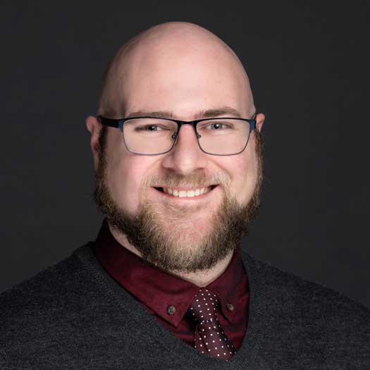 smiling man with a beard and glasses