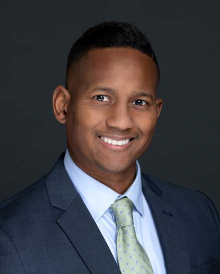 smiling man wearing a tie