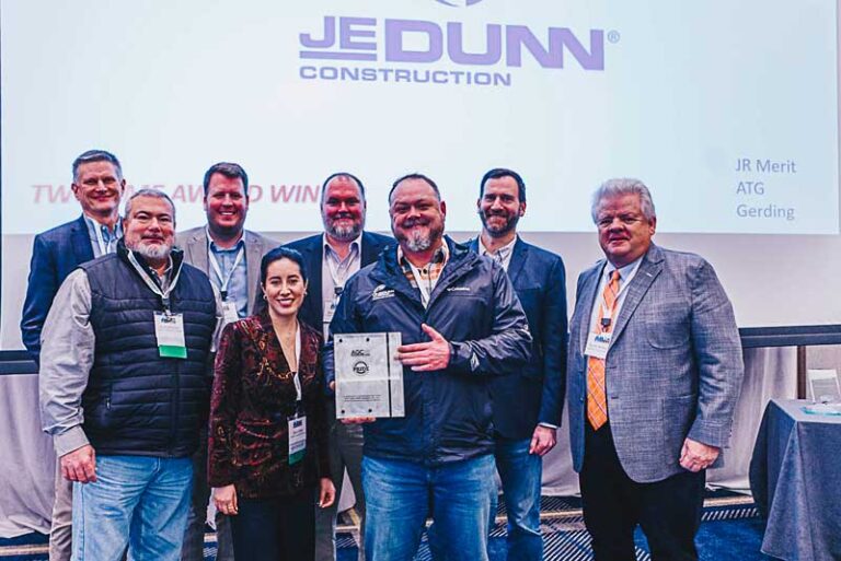 smiling people holding an award