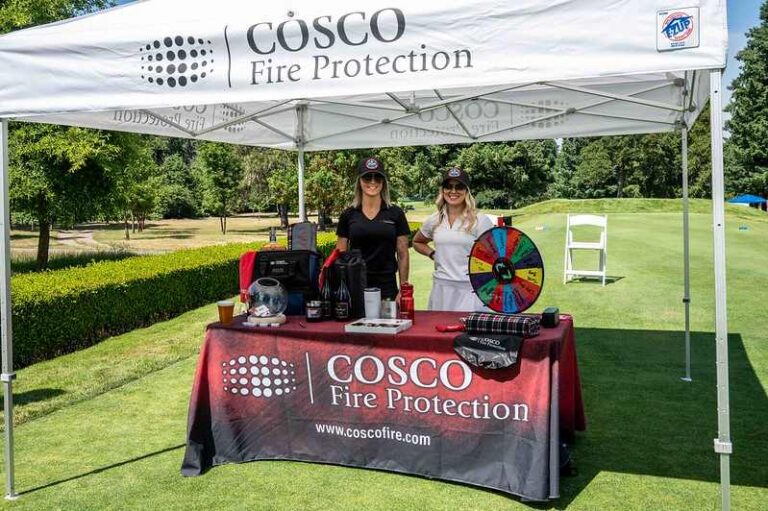 women behind table and prizes