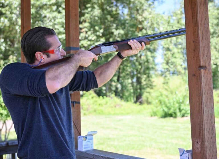 man wearing safety glasses shooting a rifle