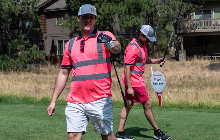 golfers dressed in safety shirts