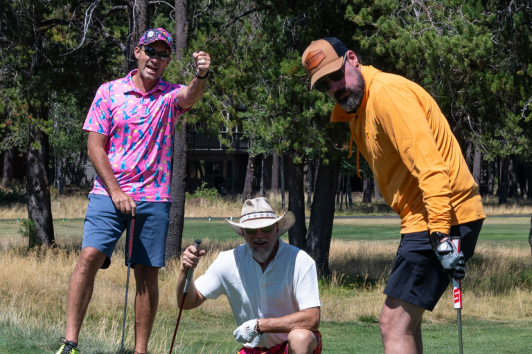golfers cheering on a putt