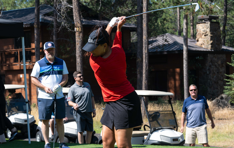woman hitting golf ball