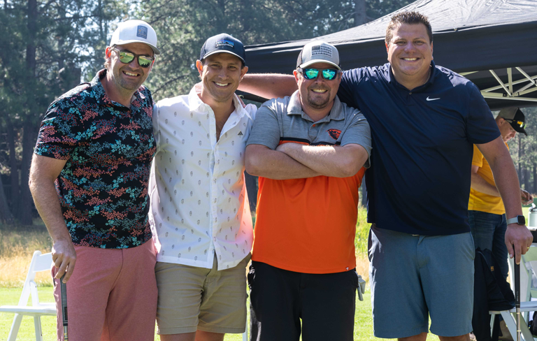 four men smiling