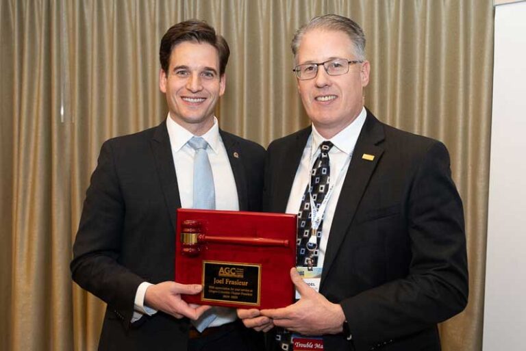 two smiling men with gavel plaque
