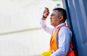 sweating man with hard hat and vest