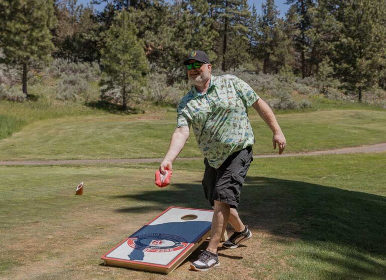man playing cornhole