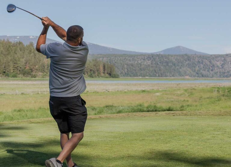 man swinging golf club