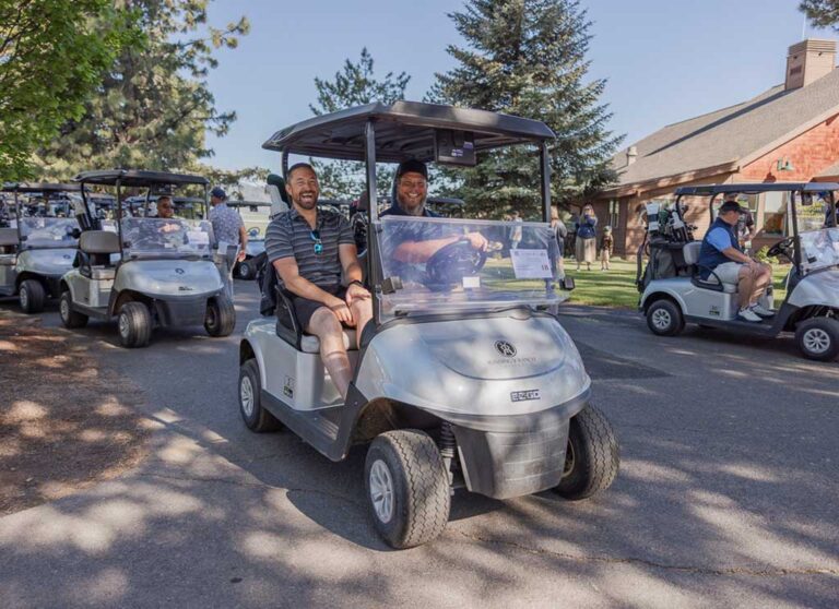 two golfers on a golf cart