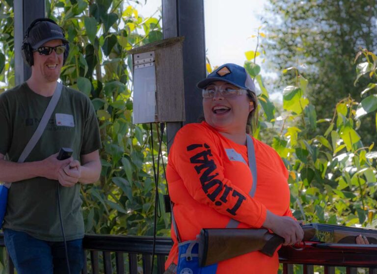smiling woman on a skeet course