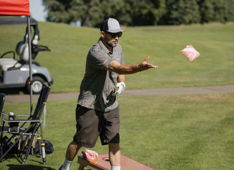 golfer throwing cornhole beanbag