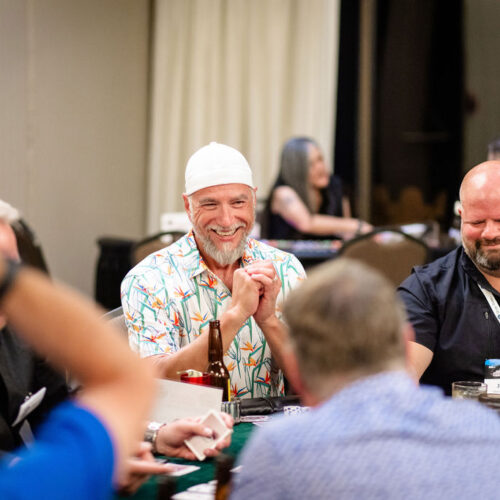 man smiling while playing poker