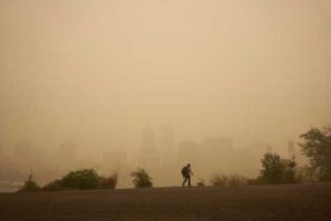 city skyline with hiker obscured by wildfire smoke