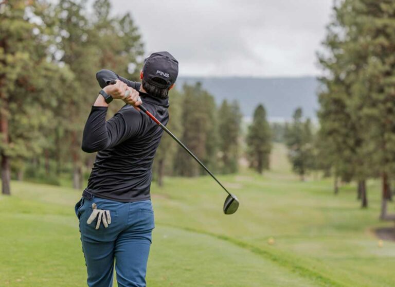 man at the end of a golf swing