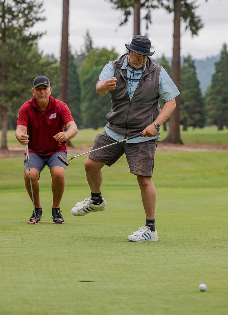a man celebrating after a putt