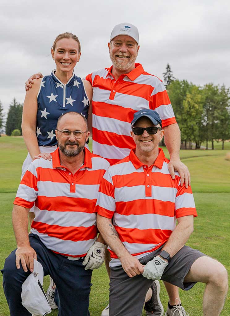 three men and a woman wearing stars and stripes golf shirts