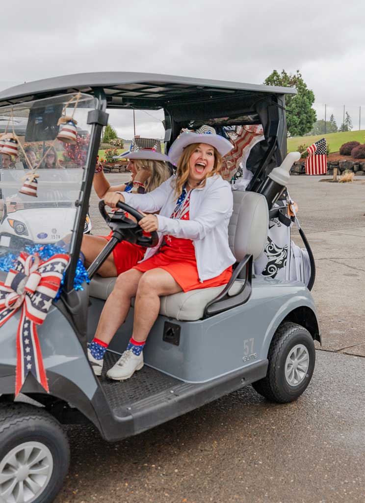 a woman in a golf card smiling