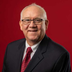 smiling man wearing a suit and glasses