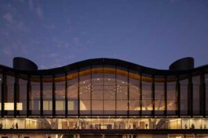 building with big windows and wavy roofline