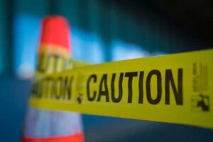 caution tape and a traffic cone