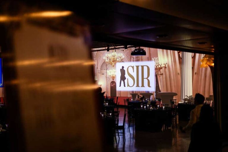 a stage with the event logo