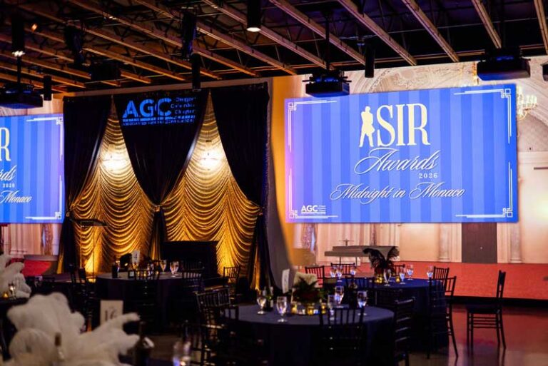 a stage and set tables at a gala